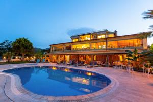 a large house with a swimming pool in front of it at Casa Di Datca in Datca