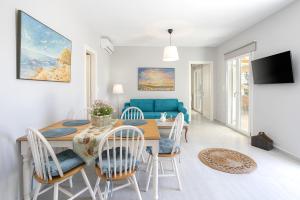 a dining room and living room with a table and chairs at MNP Apartments in Engares