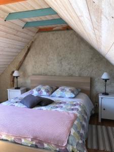 a bedroom with a bed and two night stands at La vieille ferme in Landévennec