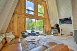 ein Wohnzimmer mit Holzwänden und einem großen Fenster in der Unterkunft Wilmington Chalet with Hot Tub Less Than 8 Mi to Mount Snow! in Wilmington
