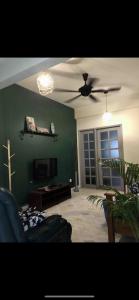 a living room with a couch and a ceiling fan at JUST NICE ,Selesa hillhome bukit tinggi bentong in Bentong