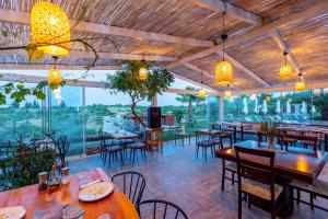 a restaurant with tables and chairs and windows at Casa Di Datca in Datca
