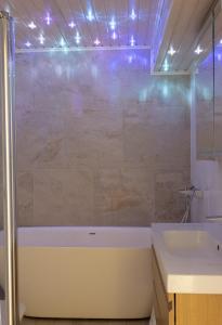 a bathroom with a tub and a sink and a shower at 2ndhomes Luxurious 144 m2 Stylish 3 Bedroom Center Apartment in Helsinki