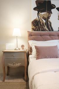 a bedroom with a bed and a side table with a lamp at Remvi in Komotini
