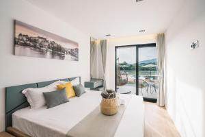 a bedroom with a bed and a large window at La Mandarine in Ulcinj +83 photos
