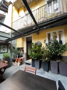 a patio with a table and a bunch of plants at Charming Room in the heart of Locarno in Locarno
