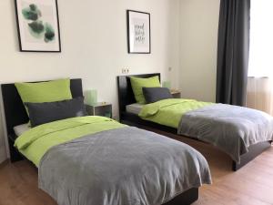 a bedroom with two beds and a couch at Haus Am Spitalgarten für 10 Personen in Gundelfingen an der Donau