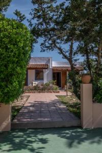 a house with a pathway leading to the front yard at Aguamar - Emar Hotels in Playa Migjorn