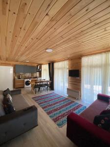 a living room with a couch and a dining room at Ayder Gencal Villa in Ayder Yaylasi
