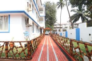 a wooden bridge over a street with a building at Blue Lagoon Benaulim Goa in Marmagao