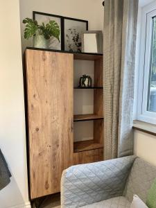 a wooden cabinet in a room with a window at Studio16 in Bristol