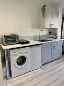 a kitchen with a washing machine and a sink at Studio16 in Bristol