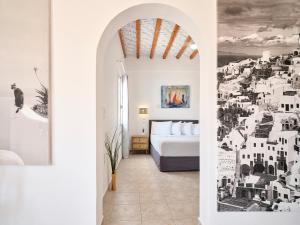 a bedroom with a bed and a mural of buildings at Milaki Kimolos in Kimolos