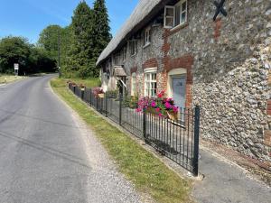 a stone house with flowers on the side of a road at The Shears Inn in Marlborough