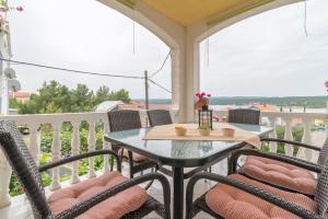 a patio with a table and chairs on a balcony at Apartments Punta in Kruševo