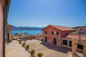 a view of the water from a building at La Suite del Faro - HelloElba in Portoferraio
