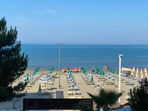 a beach with chairs and umbrellas and the ocean at RUMAR HOTEL in Durrës