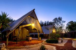 a large building with a pitched roof at night at Urban Camp in Windhoek