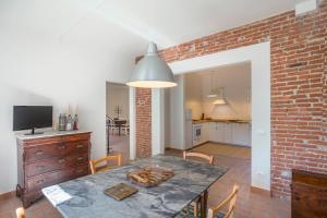 a kitchen and dining room with a brick wall at Podere Belvedere Livorno in Livorno