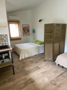 a bedroom with two beds and a window at Les Chêneslierres in Lourmarin
