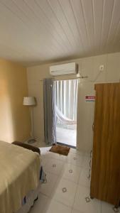 a bedroom with a bed and a window in a room at Manancial Flats in Maragogi