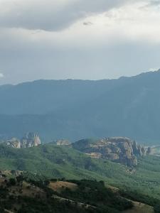 a view of the mountains from an airplane at Meteora's sunset in Kalabaka