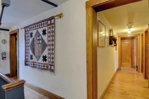 a hallway with a rug hanging on a wall at Melville House Newport in Newport