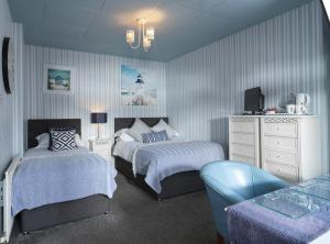 1 dormitorio con 2 camas y vestidor en Howarth House, en Lytham St Annes