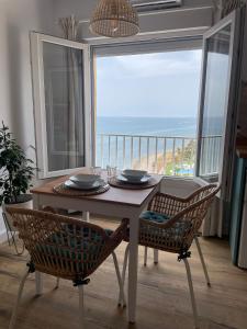a table and chairs with a view of the ocean at Studio on the Beach Front in Sitio de Calahonda