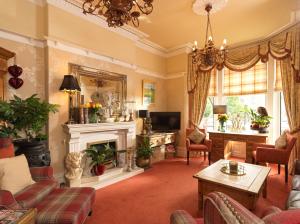 a living room with a fireplace and a tv at Howarth House in Lytham St Annes