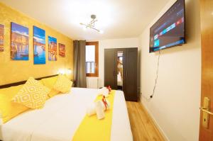 a bedroom with a bed with a tv on the wall at DolceVita Apartments N 500 San Marco in Venice