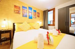 a hotel room with a bed with towels on it at DolceVita Apartments N 500 San Marco in Venice +42 photos