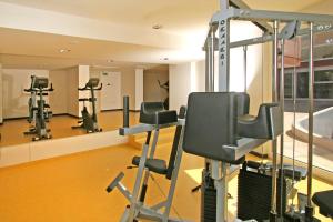 a gym with tread machines and a mirror at Hotel Albatros Plava Laguna in Poreč