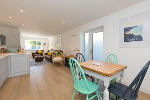 a kitchen and living room with a table and chairs at Hillywych Studio in Redruth