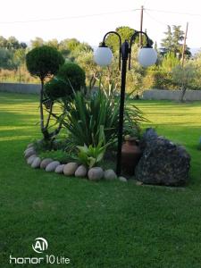 a lamp post in the middle of a lawn at Avra Ηouse in Kriopigi