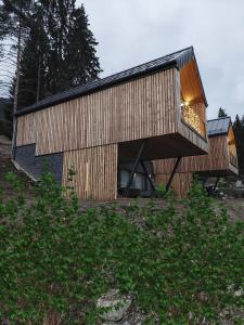 a large wooden building with a large window at Wellness chalet Vénus in Liptovský Mikuláš