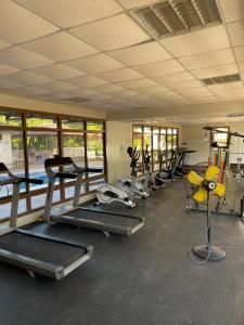 a gym with a row of treadmills and machines at 3-bedroom apartment by Mas in Dar es Salaam