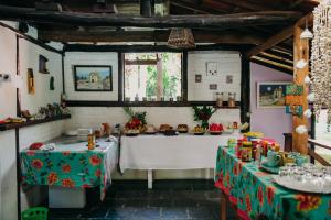 a dining room with two tables in a room at Pousada Arraial Lua Crescente in Arraial d'Ajuda