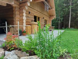 a log cabin with a garden in front of it at Ferienhaus - Chalet - Lechtraum in Stanzach