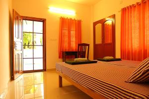 a bedroom with two beds and an open window at Aleenas homestay in Cochin