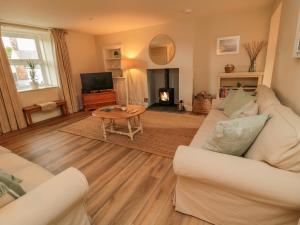 a living room with a white couch and a table at 46 Castle Street in Berwick-Upon-Tweed