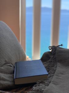 a blue book sitting on top of a couch at Villa Orca in Podaca
