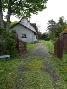 a house with a fence next to a road at Gite Rural in Eygurande
