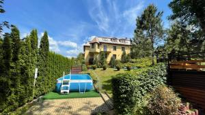 a house with a swimming pool in the yard at Villa Gorczańska in Rabka-Zdrój