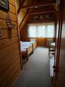 Posteľ alebo postele v izbe v ubytovaní Chata Sosnówka Residence