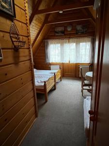 a small room with a bed and a window at Chata Sosnówka Residence in Sosnówka