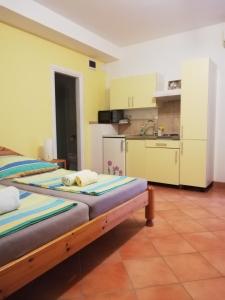 two beds in a room with a kitchen at Villa Maslina in Zadar