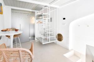 a room with white walls and a white table and chair at Corte Giotto Exclusive House in Carovigno