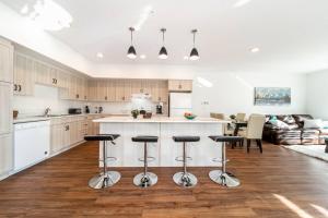 a kitchen with a counter and bar stools at Spacious 2bedroom FREE parking king bed close to DT in Edmonton
