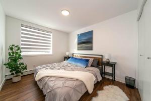 a bedroom with a large bed and a window at Spacious 2bedroom FREE parking king bed close to DT in Edmonton